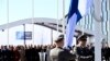 Militares de Finlandia izan la bandera nacional frente a la sede de la OTAN en Bruselas, Bélgica, el 4 de abril de 2023 (John Thys/AFP).